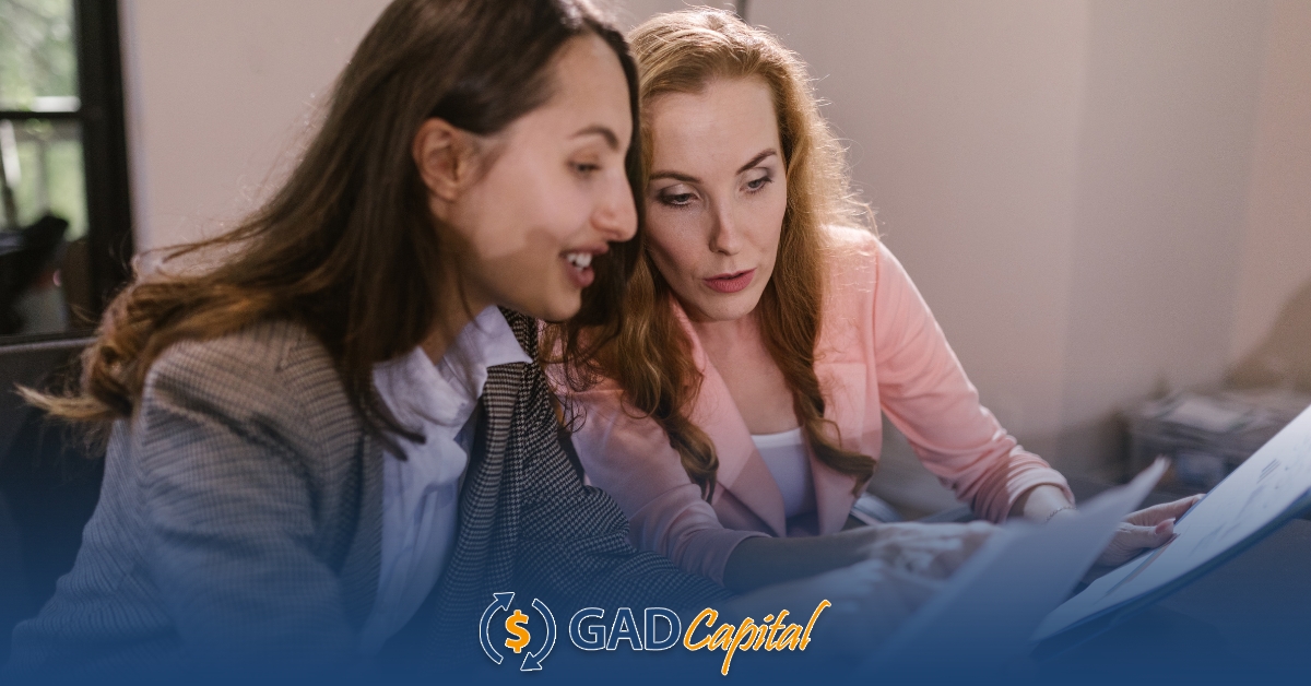 Two women looking at a computer screen together comparing Nevada title loans