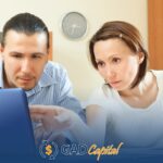 A man and woman looking at a laptop screen comparing title loans in Pennsylvania
